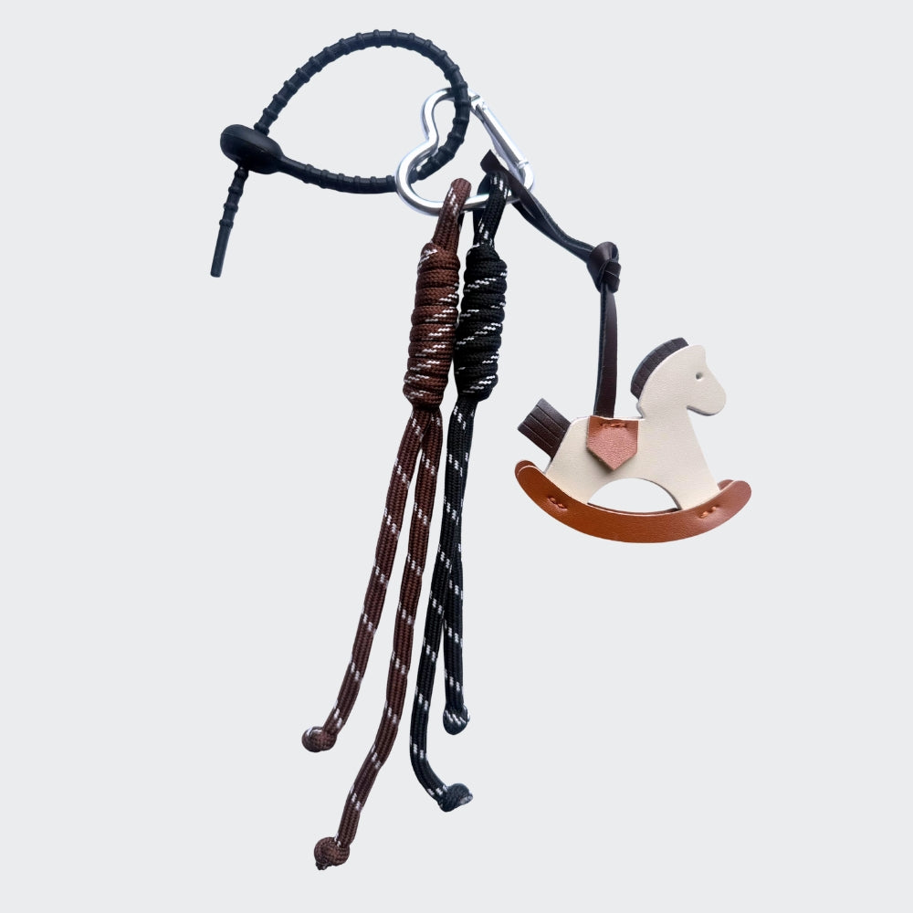 Decorative keychain with rocking horse design on a white background